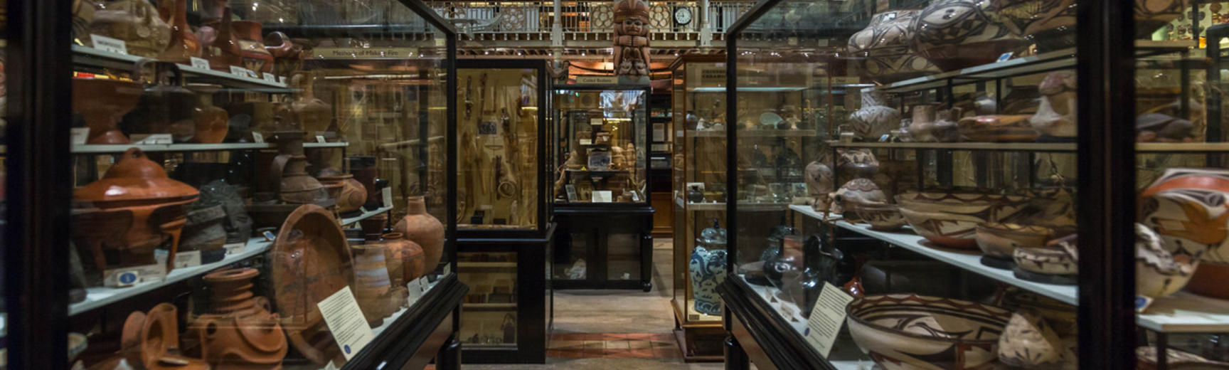 View between display cases towards totem pole