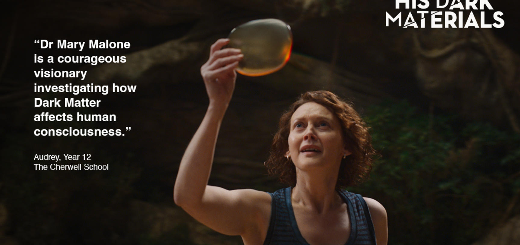 A woman holds a golden transparent disc