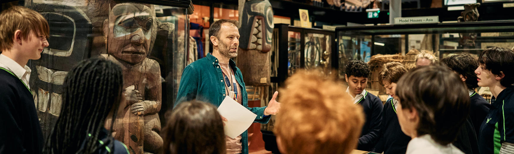 Students listening to Education Officer in museum galleries