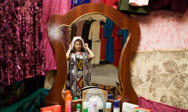 A newly-wed woman dressing in traditional Uzbek clothes. Khanabad, Uzbekistan. Photograph by Carolyn Drake. April 2007.