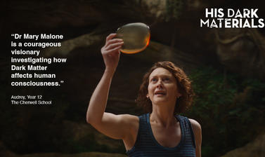 A woman holds a golden transparent disc