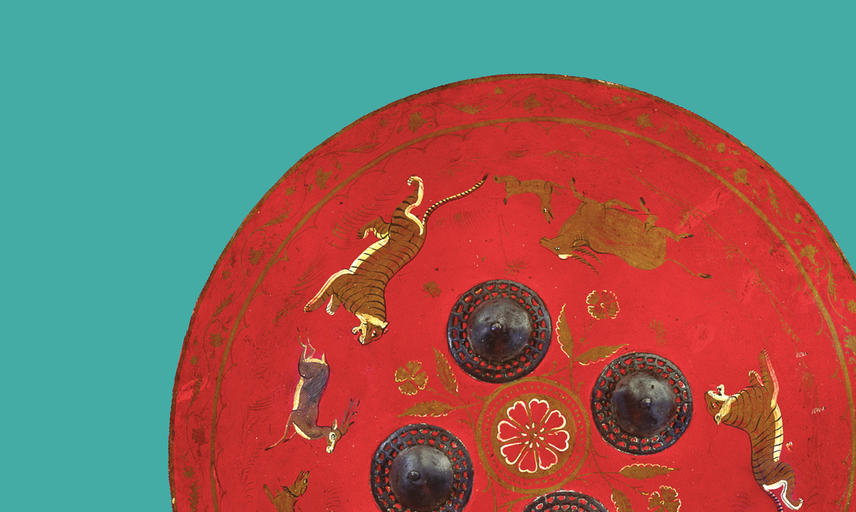 Detail of a round red shield painted with animals and floral motifs