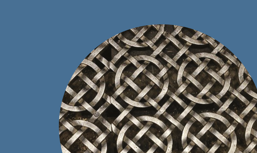 Photo detail showing an iron floor grid made up of interlocking lines and circles
