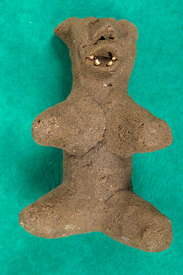 Clay figure with open mouth with teeth