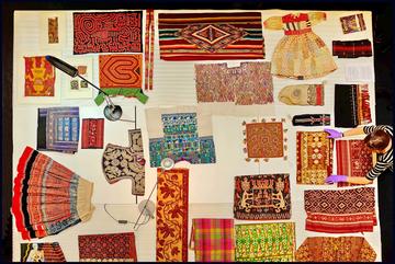 View from above of colourful textiles being laid out on table